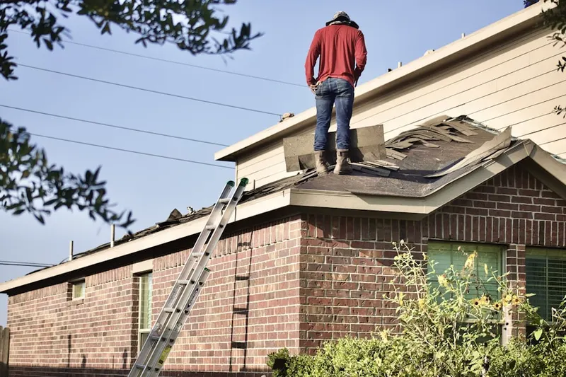 Professional roofer working on a residential roof in Upper Land Park